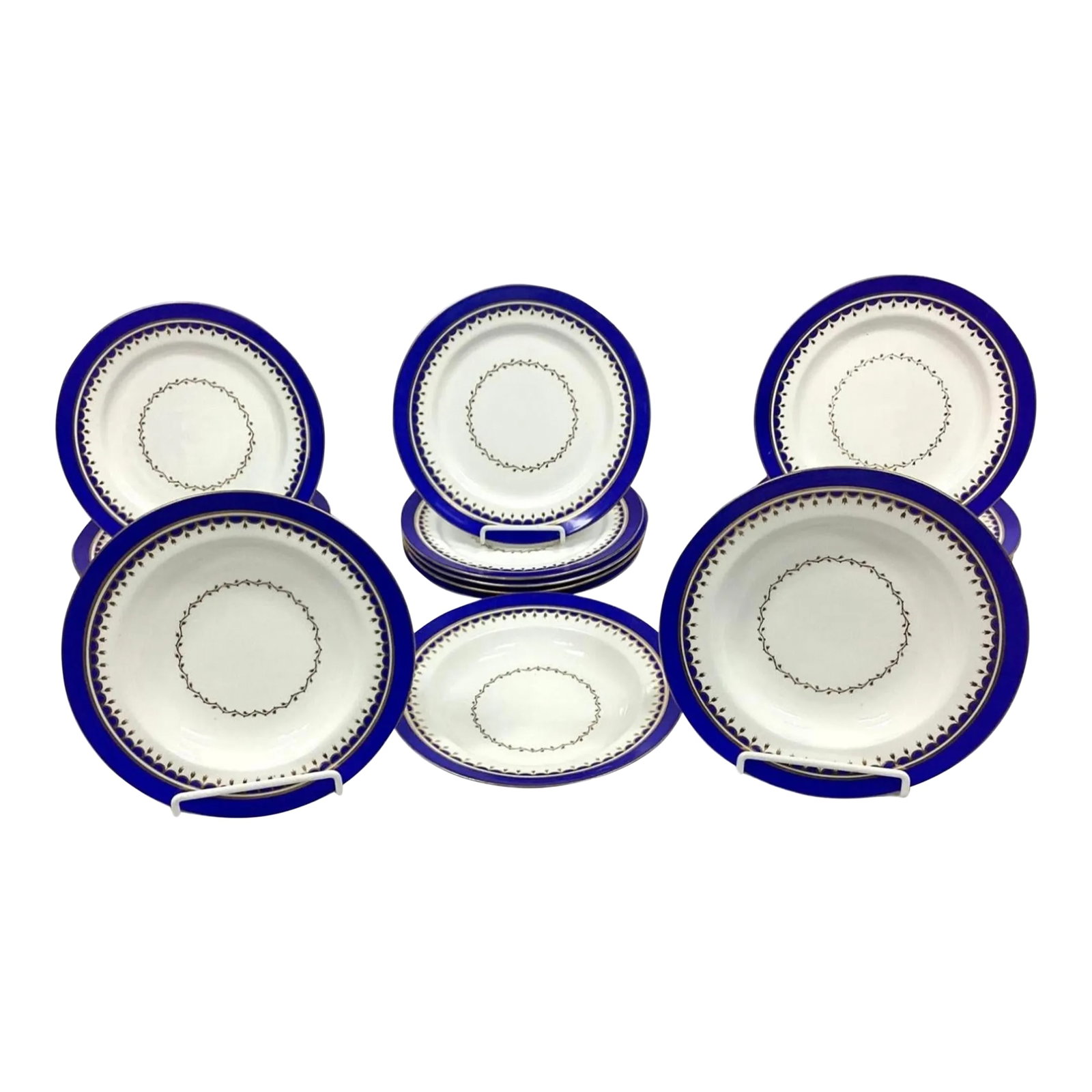 Set of Vintage Porcelain Dinner Plates and Bowls, Early 20th Century: Set of early 20th Century Porcelain Dinner Plates (16 total) and large bowls (3 total). Beautiful cobalt blue on edge with smooth gold trim and tiny gold leaves in center. No markings on reverse side.