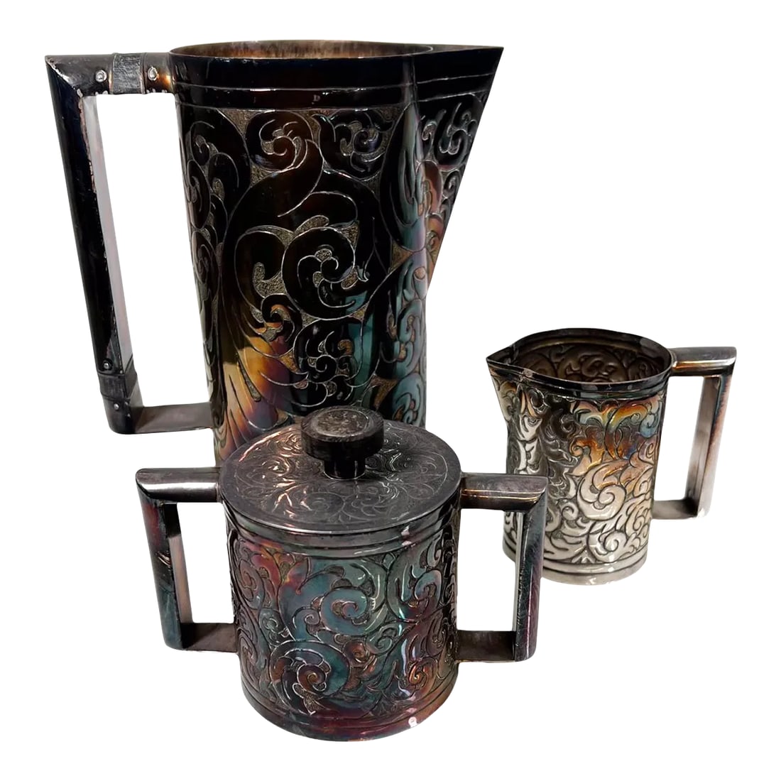1900s Hand Wrought Embossed Sterling Silver Pitcher Set Creamer and Sugar: AMBIANIC presents Fabulous Antique Modern Hand Wrought Sterling Silver Pitcher Creamer Sugar Set Relief embossed repousse design. Pitcher 7.38 tall x 6.88 D x 3.75 W, Creamer 3.38 H x 3.88 D x 2.25 W,