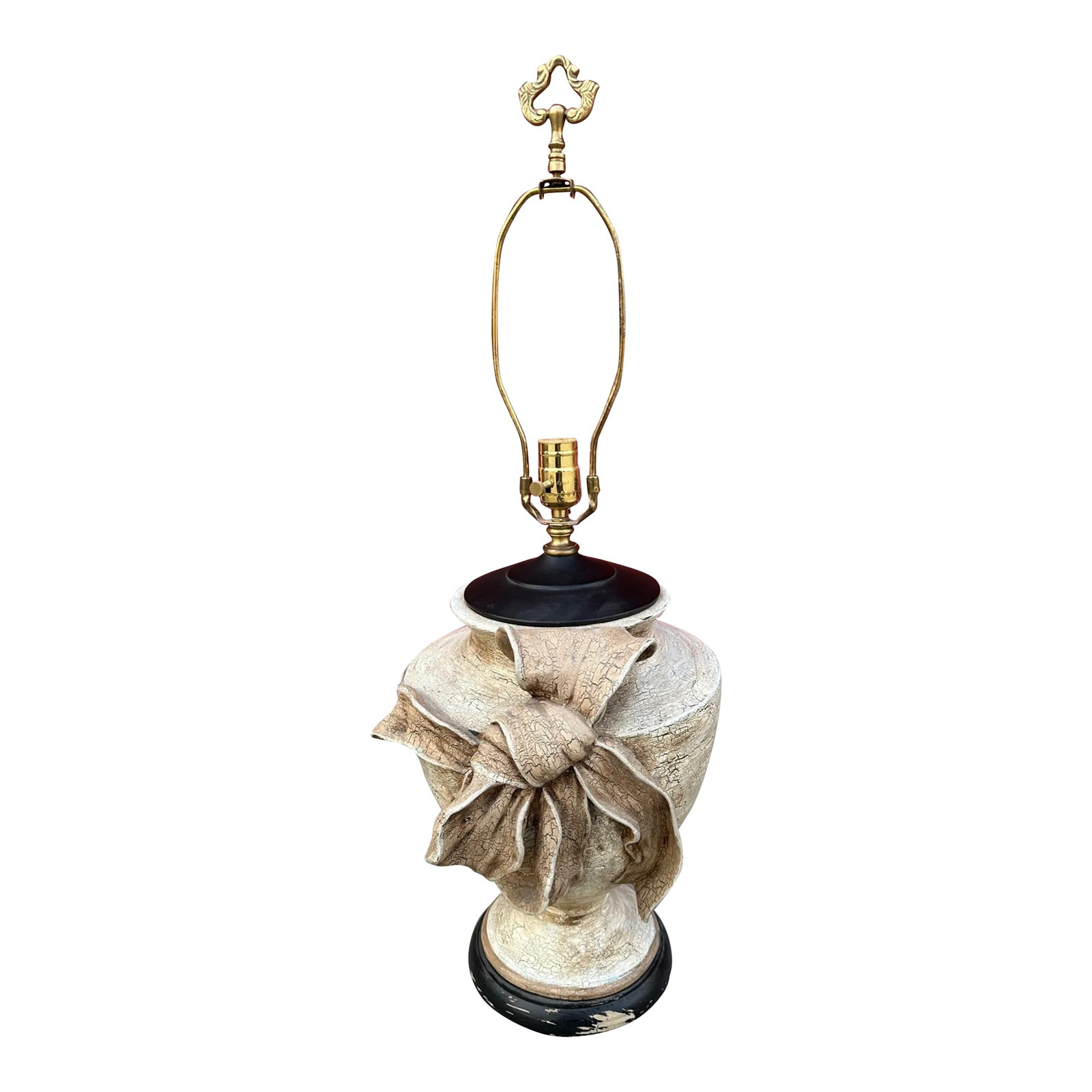 Vintage Crackle Finish Urn W/Bow Table Lamp: Rustic European Vintage Crackle Finish Urn Style Lamp with a large bow on front. Neutral color with a black top and bass. Brass finial. Distressed look, looks like wood but ceramic with wood base. 20.