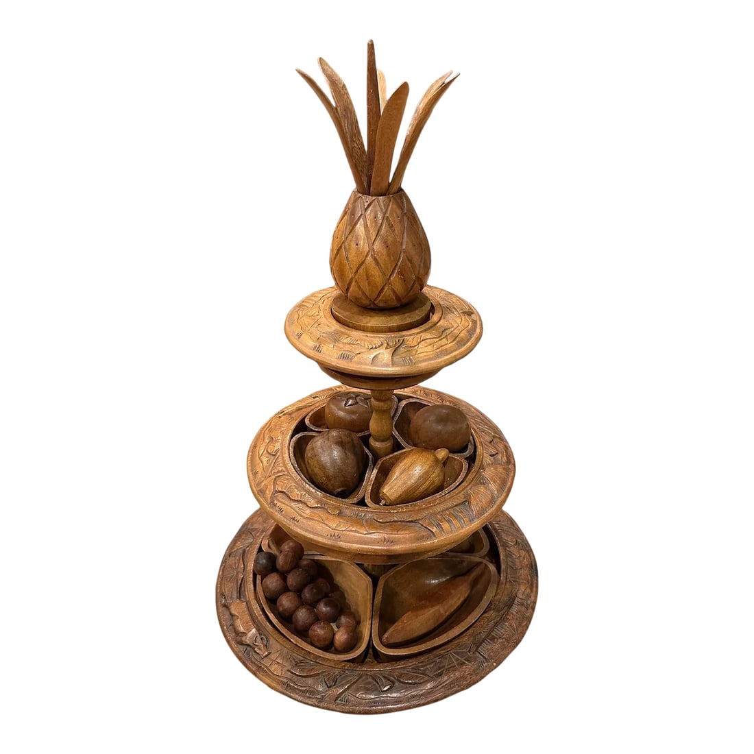 Mid-Century Modern Pineapple Topped Lazy Suzan Epergne Monkey Pod Wood and Decorative Fruit Set- 29: You are viewing a tall 3-tiered lazy susan/Epergne in an island style motif. Includes 9 pieces of hand carved wood decorative fruit. Hand carved island village scenes including grass huts, trees, wate