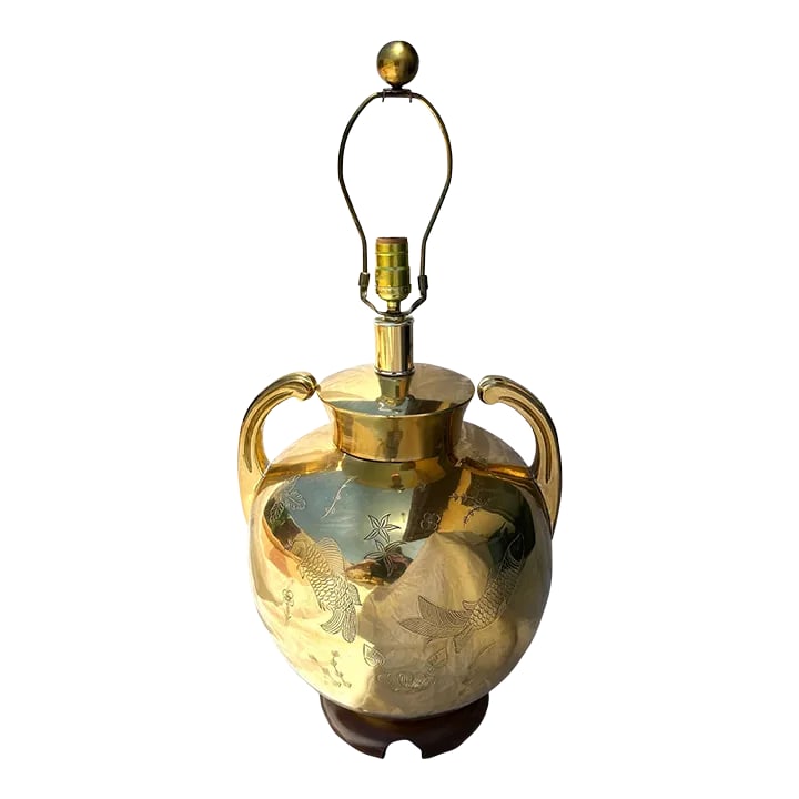 Vintage Brass Chinoiserie Urn Table Lamp: Vintage Brass Chinoiserie Etched Koi Fish Design Urn Table Lamp with a wood base. Large handles with a brass finial. Etched Koi Fish and water lily throughout. Perfect for a Hollywood Regency or MCM H