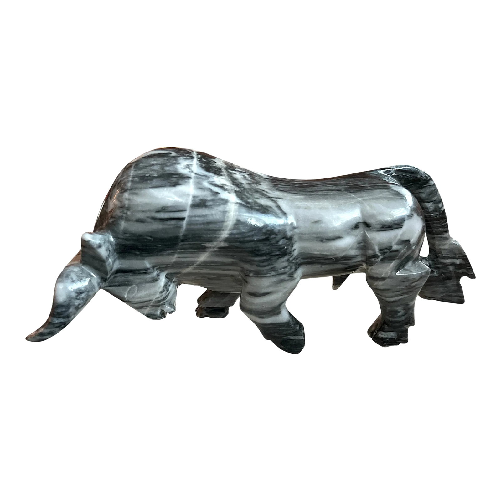 1970s Hand Carved Black & White Italian Marble Bull Sculpture: Sculpture of a bull made from a polished marbled stone. The bull is depicted in a dynamic pose, with its head lowered and horns pointed forward, conveying strength and determination. The stone has a