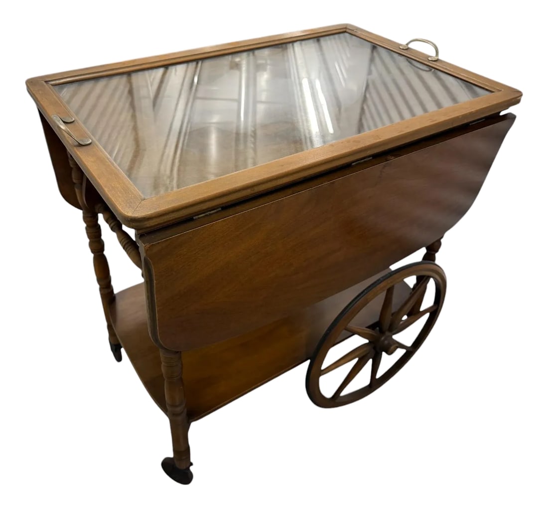 Bar Tea Cart With Glass Tray: Quick Hits: * Vintage wood tea cart with detachable glass serving tray * Drop-leaf sides for adjustable surface area * Smooth-rolling large spoke wheels and rear casters * Charming cottage, colonial, 