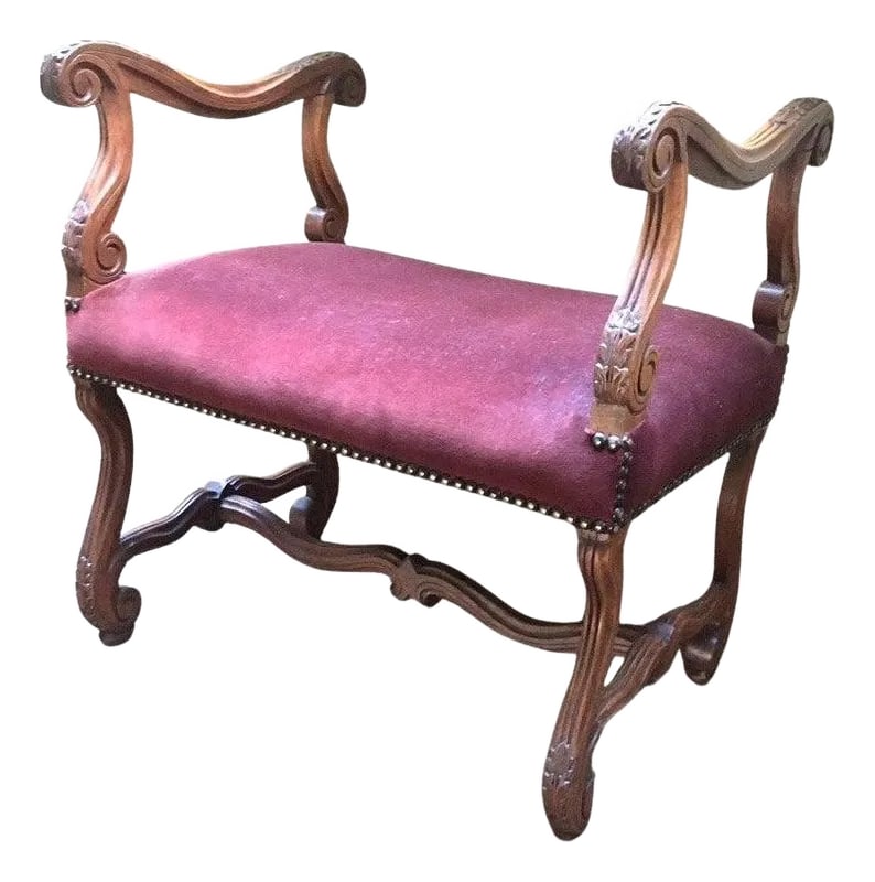 Antique French Walnut Short Upholstered Bench W/ Serpentine Arms & Stretcher: This handsome French walnut bench features curvilinear arms with carved acanthus leaves and is supported by a carved serpentine stretcher base. The seat is a lovely claret colored velvet bound by
