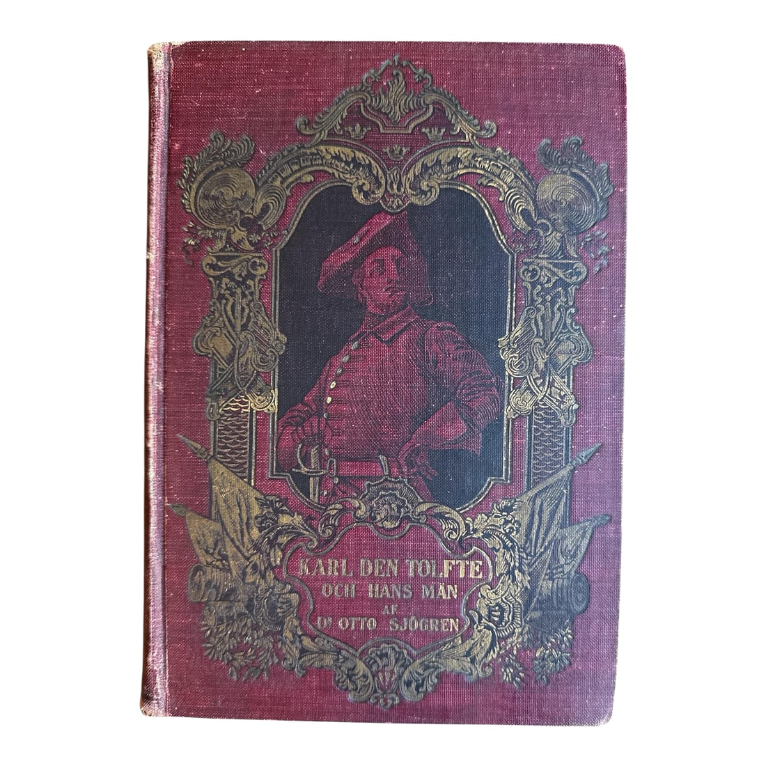 1903 Antique Historical Literature Hardcover-Swedish 'Karl Den Tolfte Och Hans Man Lifsbilder Fran S: Offering an antique red cloth hardcover book written in Swedish "Karl den Tolfte och hans man" (Charles XII and his men) by Otto Sjogren. Ornately illustrated front cover featuring an image of Charles