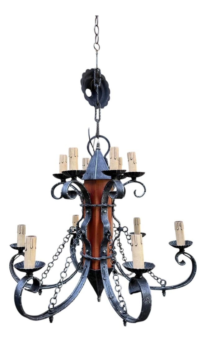 Made in Italy Mediterranean Revival Wrought Iron Style 12 Light Candle Chandelier: Offering a vintage castle-era chandelier inspired by historical periods known for their elaborate ironwork and grand fixtures. It retains the original metal tag marked 'Made in Italy'- a