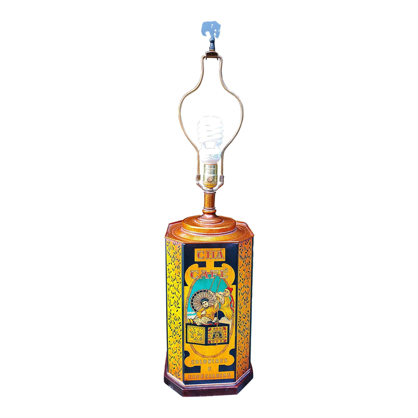 Vintage Frederick Cooper Tin Tea Canister Lamp With Silk Shade: A rare and distinctive Frederick Cooper table lamp, crafted from a vintage European tea canister. The hexagonal tin base features richly detailed graphics in warm tones, with the words "Tha Cafe - Col