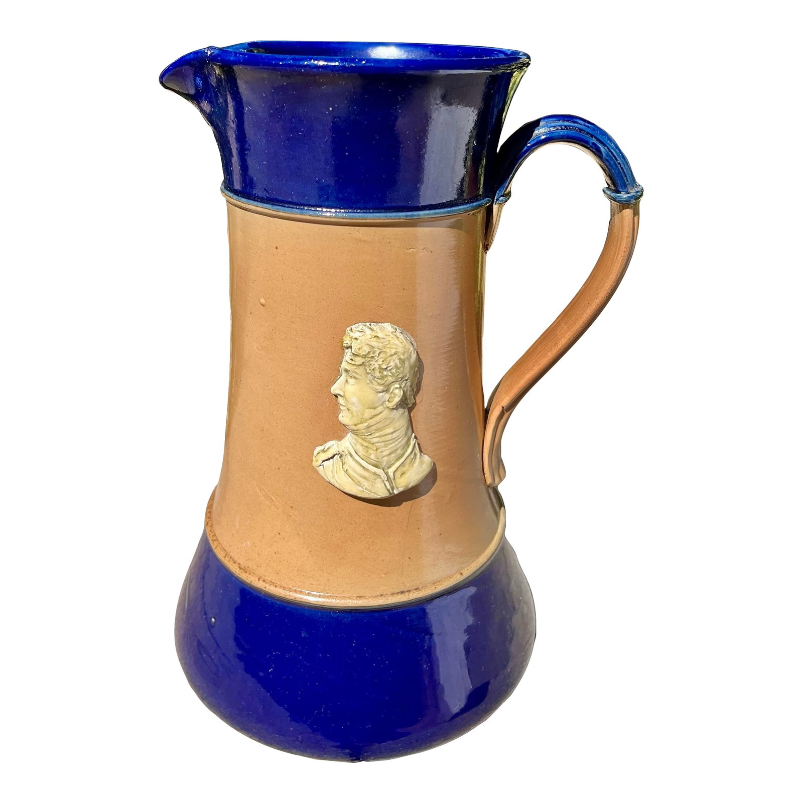 Antique Royal Doulton Stoneware Jug/Pitcher, King George IV John Doulton: Large stoneware pitcher in blue and brown coloration with portraits of King George IV and John Doulton in white relief. Impressed Royal Doulton backstamp. Condition: Alterations: Original Condition