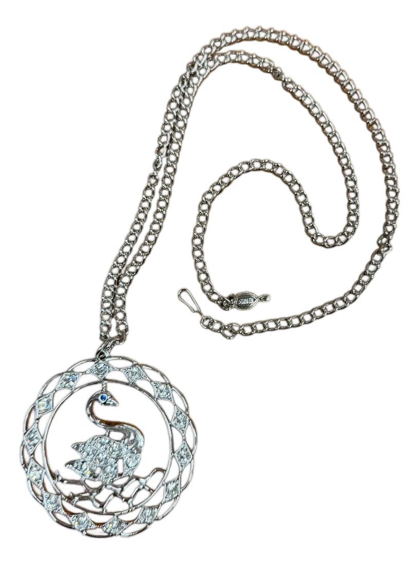 1970 Vintage Swan Rhinestone Pendant Necklace Swan Lake Sarah Coventry Costume Jewelry: Swan Pendant Necklace called "Swan Lake" mid 1970s marked Sarah Coventry. Vintage silver tone metal and rhinestone reticulated pendant on a silver tone chain. Pendant 2 1/8" diameter. Chain 24" hook