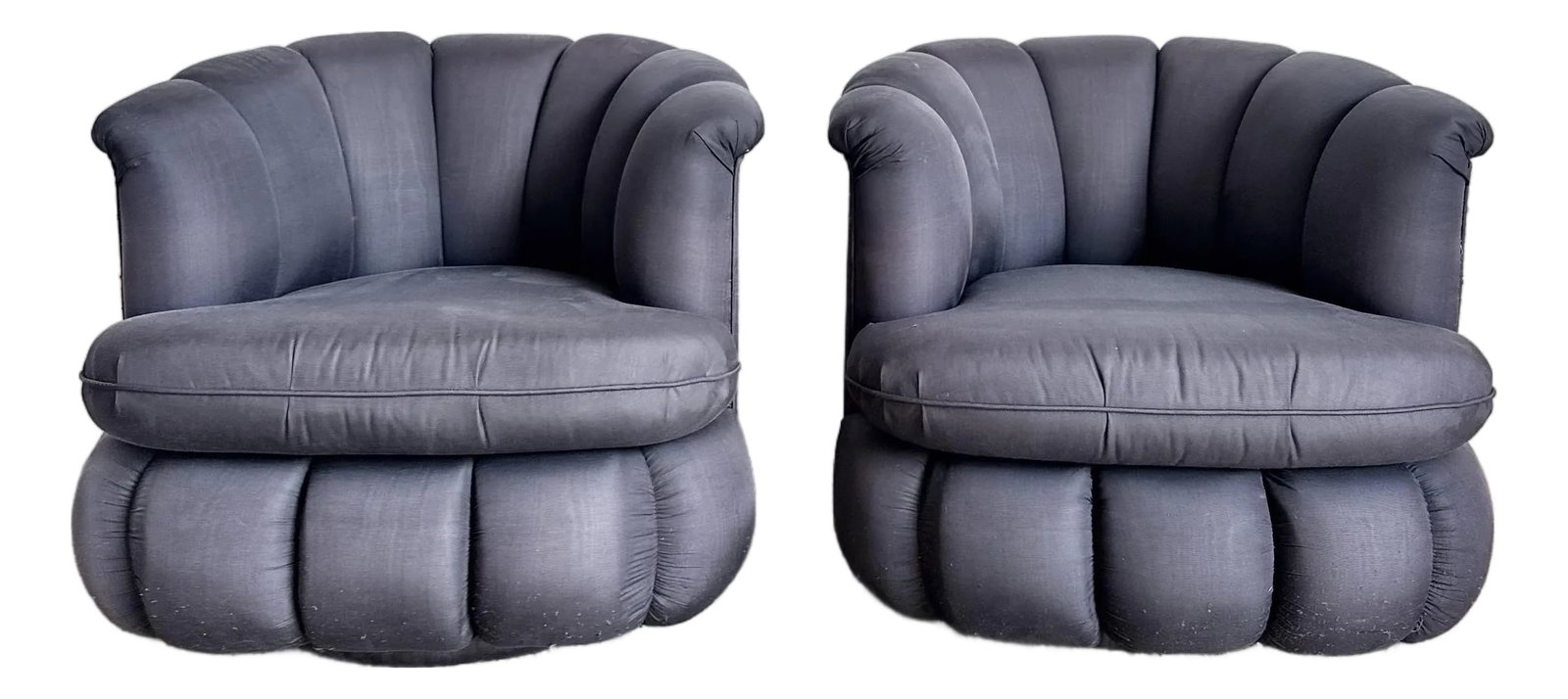 Postmodern Black Clam Shells Swivel Lounge Chairs - A Pair: This striking pair of postmodern lounge chairs features sculptural clam shell silhouettes with deeply channel-tufted upholstery that wraps the form in a bold, architectural rhythm. The rounded backs a
