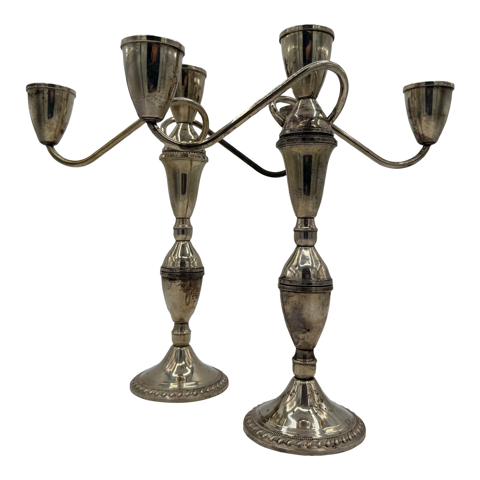 Midcentury Duchin Creation Weighted Sterling Silver Three-Way Convertible Candelabra - A Pair: A beautifully engineered pair of midcentury weighted sterling silver candelabra by Duchin Creation-with considerably more versatility than their formal silhouette first suggests. Each candelabrum is