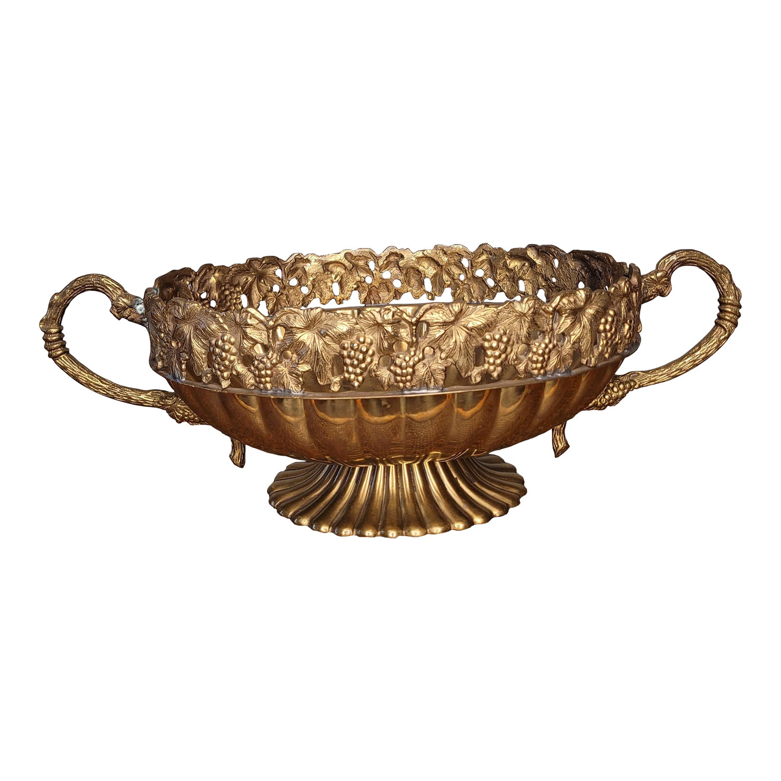 Andrea by Sadek Brass Grape Motif Pedestal Centerpiece Bowl: A classic Hollywood Regency centerpiece, this vintage brass bowl by Andrea by Sadek features an ornate, open-work grapevine design. The intricate casting showcases detailed clusters of grapes and text