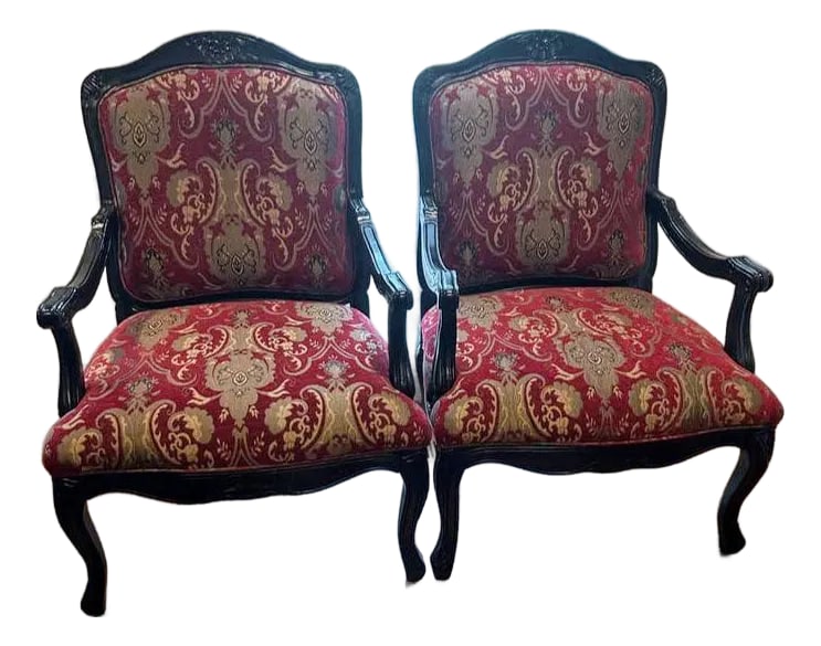 Step Into a World of Classic Elegance With This Magnificent Pair of Louis XV Style Armchairs.: Crafted with beautifully carved wooden frames and upholstered in rich warm Paisley red fabric Perfect for a study, a library, or as a distinguished accent in a living room, this pair offers both comfo