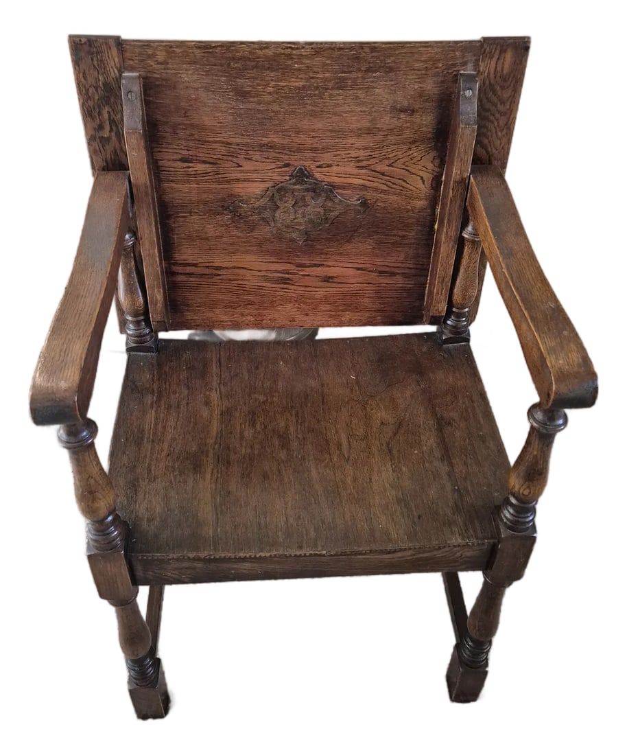 Early 20th Century Jacobean Wainscot Chair Monk's Table: This 17th century style Jacobean renaissance monk's bench and table features turned legs and a carved back panel. This model converts from a seat to a side table by pivoting the backrest down. This