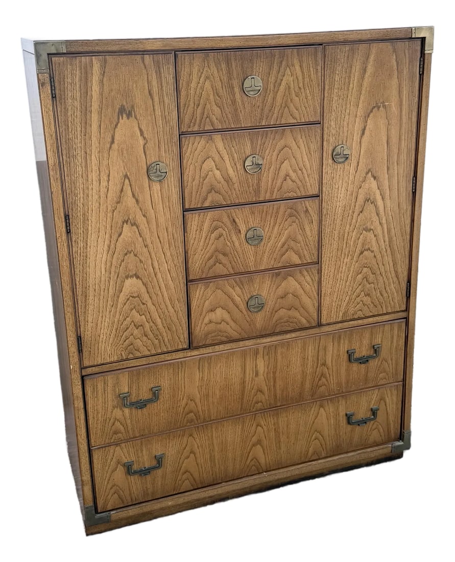 Vintage Huntley Campaign Highboy Dresser by Thomasville: A striking example of Thomasville's celebrated Huntley Collection, this vintage Campaign highboy dresser blends clean Mid-Century Modern lines with timeless British Campaign styling. Crafted in beauti