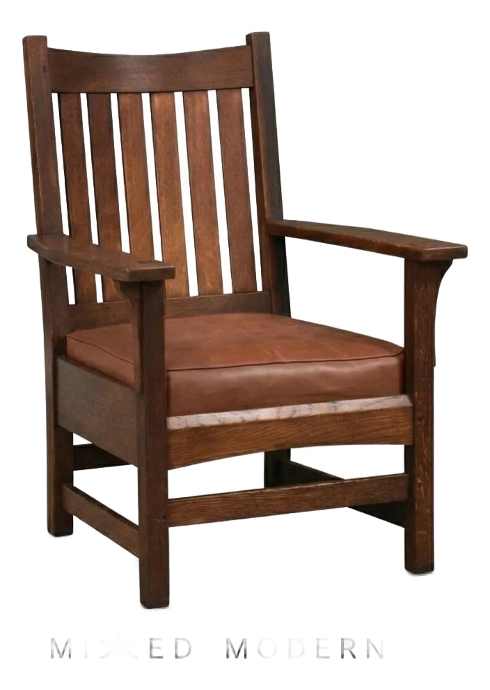 1910s L&jg Stickley Lounge Arm Chair Mission Arts and Crafts: Crafted in the enduring Arts & Crafts tradition, this L. & J.G. Stickley armchair showcases solid quarter-sawn oak, broad sculpted arms, and classic vertical slat construction. The rich finish is beau