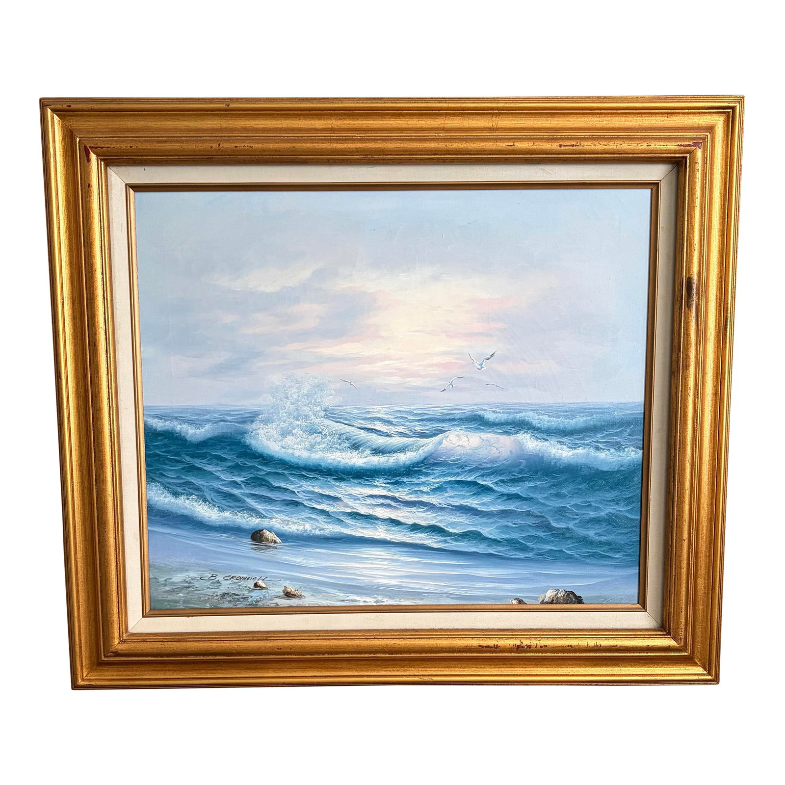 Vintage Signed Coastal Seascape Oil Painting by B. Cromwell, Circa 1970s: A luminous vintage coastal seascape oil painting depicting rolling ocean waves breaking along a rocky shoreline beneath a softly glowing sky. Rendered in layered shades of blue, teal, and seafoam
