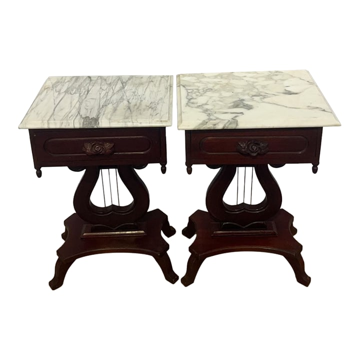 Antique American Empire Style Mahogany Lyre Parlor Tables With Distinct Italian Marble Tops - A Pair: An exceptional and beautifully preserved pair of antique American Empire style mahogany parlor tables, dating to the late 19th or early 20th century. Masterfully crafted from solid mahogany with a ric