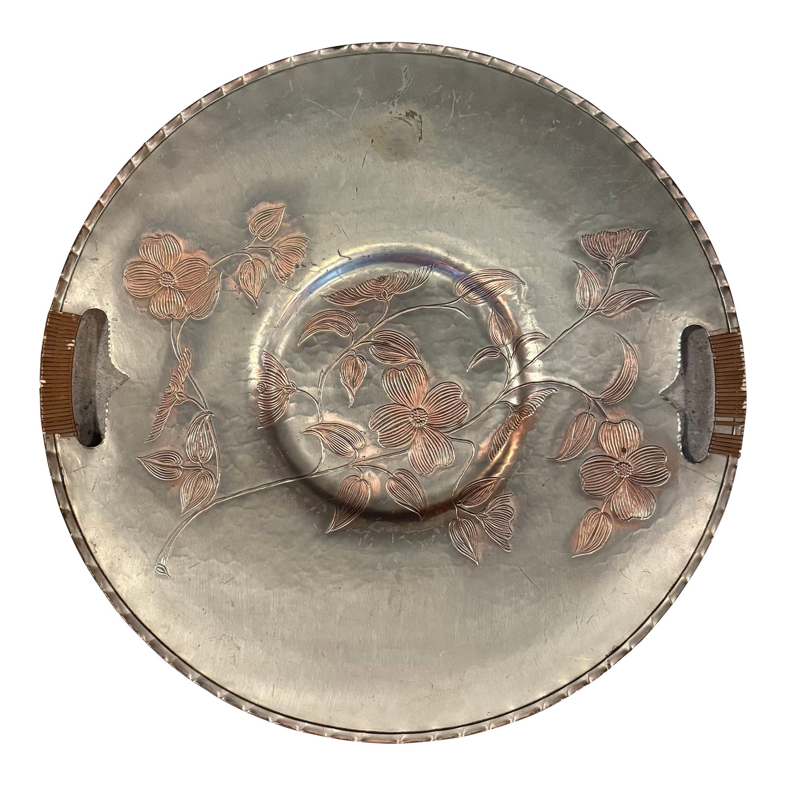 Mid 20th Century Large Aluminum and Rattan Decorative Floral Motif Serving Tray: This large mid-century hand-wrought aluminum serving tray platter features etched dogwood floral motif in a warm copper wash. The cutout handles are wrapped in original rattan, paired with a classic