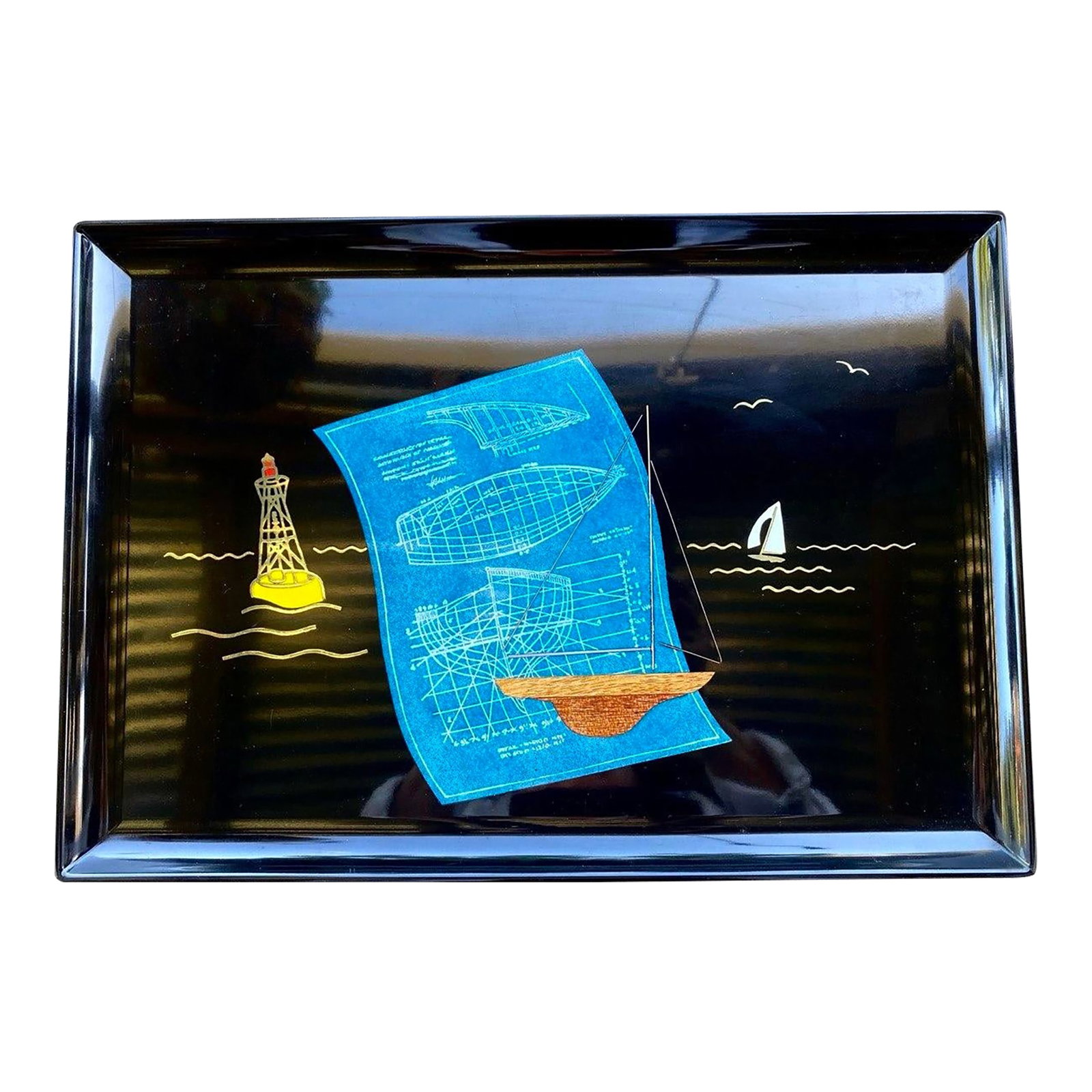Mid 20th Century Blueprints Under Sail Serving Tray: There is something wonderfully unexpected about this Couroc design. Rather than depicting a sailboat simply gliding across the water, the artist invites us into the creative process itself. A