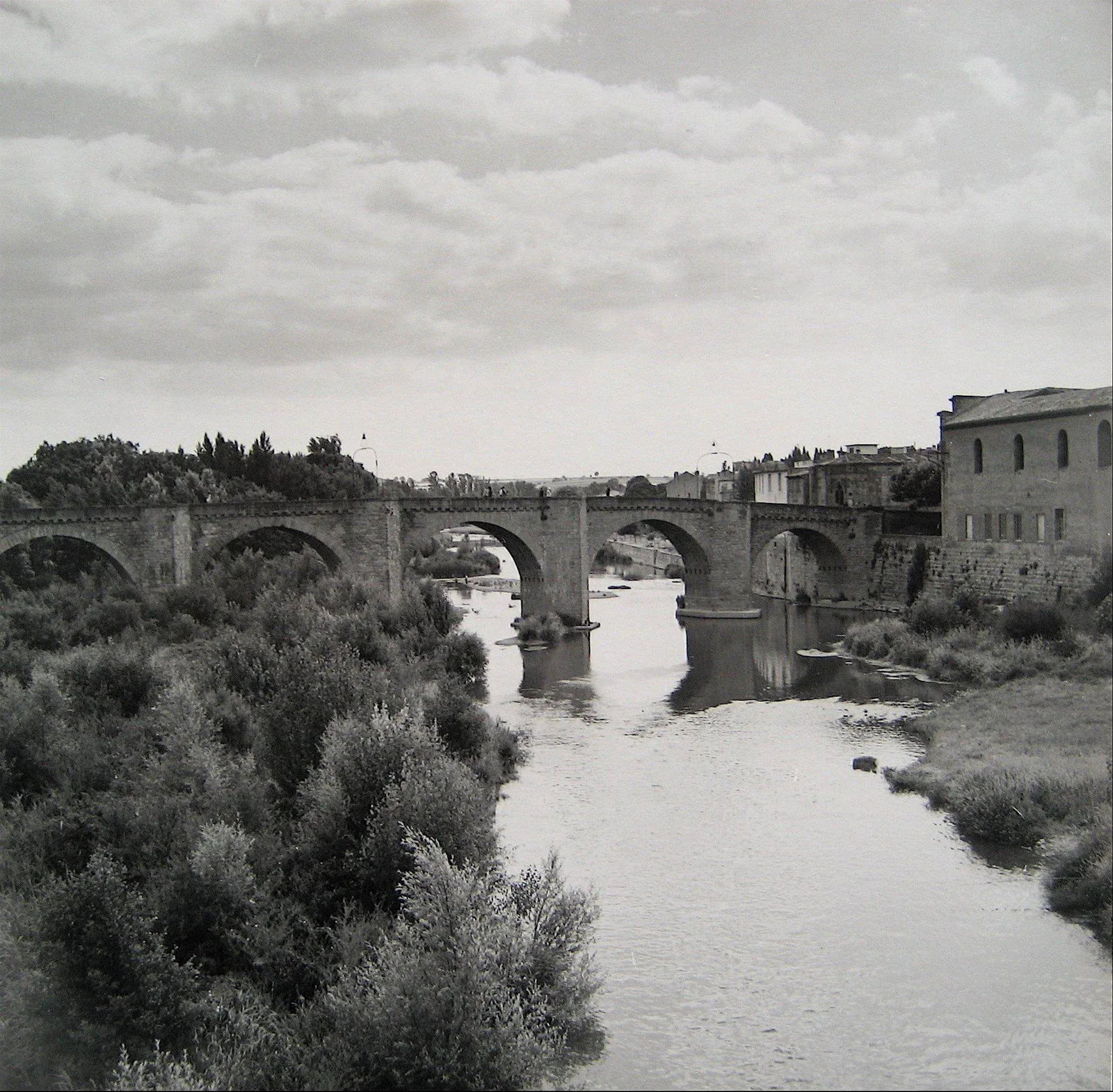 European Bridge Over Water 1960s Black and White Photograph: This work is a 1960s photograph by New York/San Francisco photographer Roz Joseph (1926-2019). Joseph traveled extensively through Europe, North Africa, and Asia in the 1960s shooting in black and whi