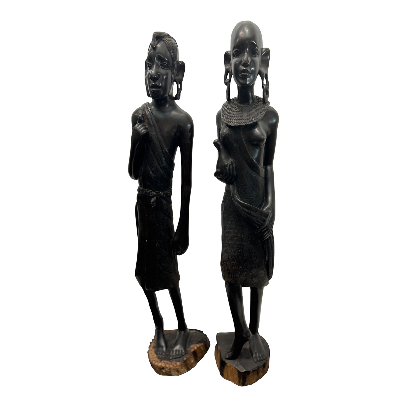 1950s Maasai Figures From Tanzania, African Blackwood (Pair): This is a matched pair of tall carved Maasai figures from Tanzania, executed in solid African Blackwood (Mpingo), one of the densest, heaviest, and most valuable carving woods in the world. The male