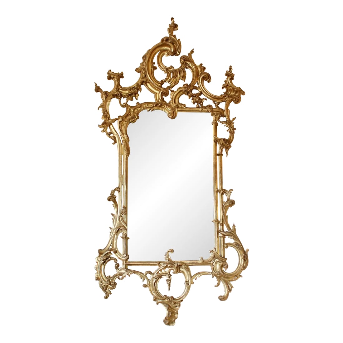 Italian Carved and Gilded Chippendale Rococo Style Mirror: A very well carved Italian giltwood mirror in the George III style with exuberant asymmetrical Rococo motifs well executed and well balanced. Good condition. The gilding is bright with typical light w