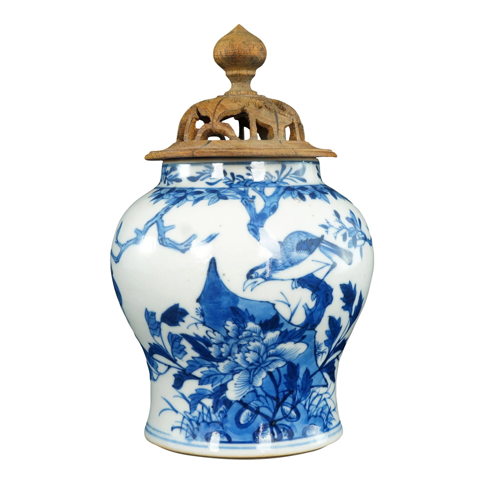 Chinese Ginger Jar Bird Motif 19th Century: A hand thrown and hand painted Qing era ginger jar with an artistic design of a bird perched in a tree with a peony in bloom. The cobalt under glaze is a very deep blue with paler shades. The foot is