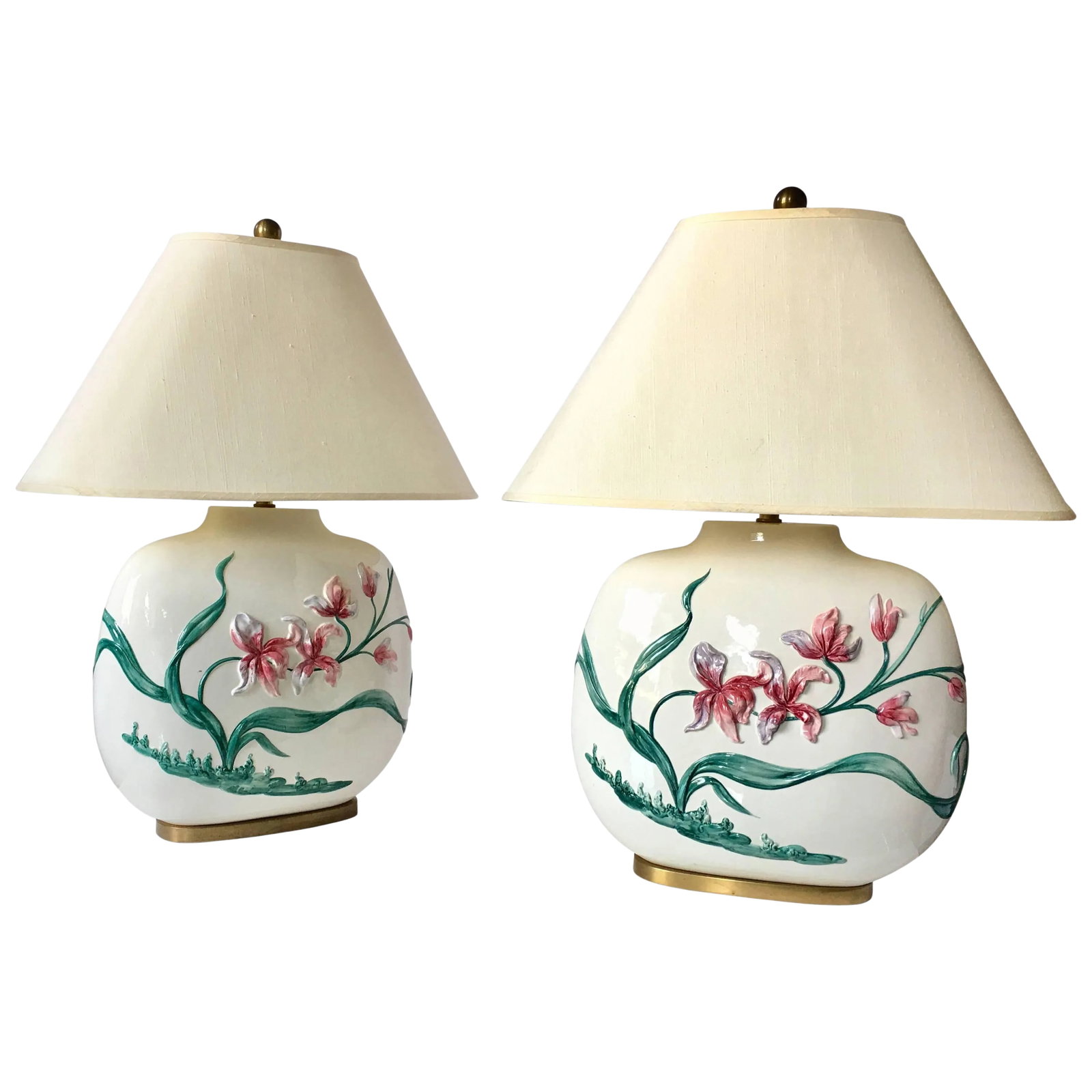Chinoiserie Style Floral Table Lamps by Chapman, Pair: Beautiful pair of chinoiserie style hand-painted floral motif table lamps by Chapman. Oval shaped glazed ceramic bodies feature a dimensional two-sided flowing floral design and brass bases. Origonal