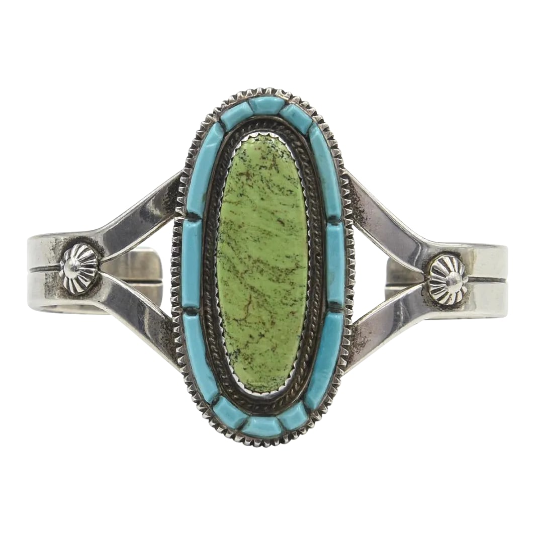Vintage Navajo Native American Turquoise and Sterling Silver Cuff Bracelet by Tom David: This is part of Chairish's Costume Jewelry assortment. Native American sterling silver cuff bracelet by Navajo silversmith Tom David featuring an oval saw tooth set green turquoise within a blue