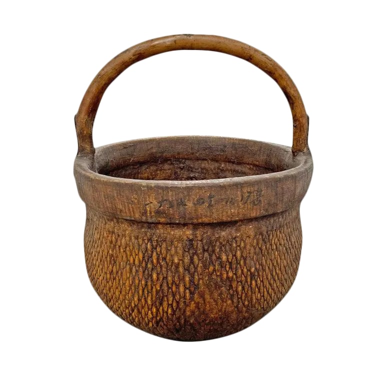 Mid-20th Century Chinese Woven Reed Basket: A mid-20th century Chinese woven reed gathering basket with a thick bentwood handle attached with simple iron straps, and covered in lacquered fabric for added strength. Condition: Alterations: