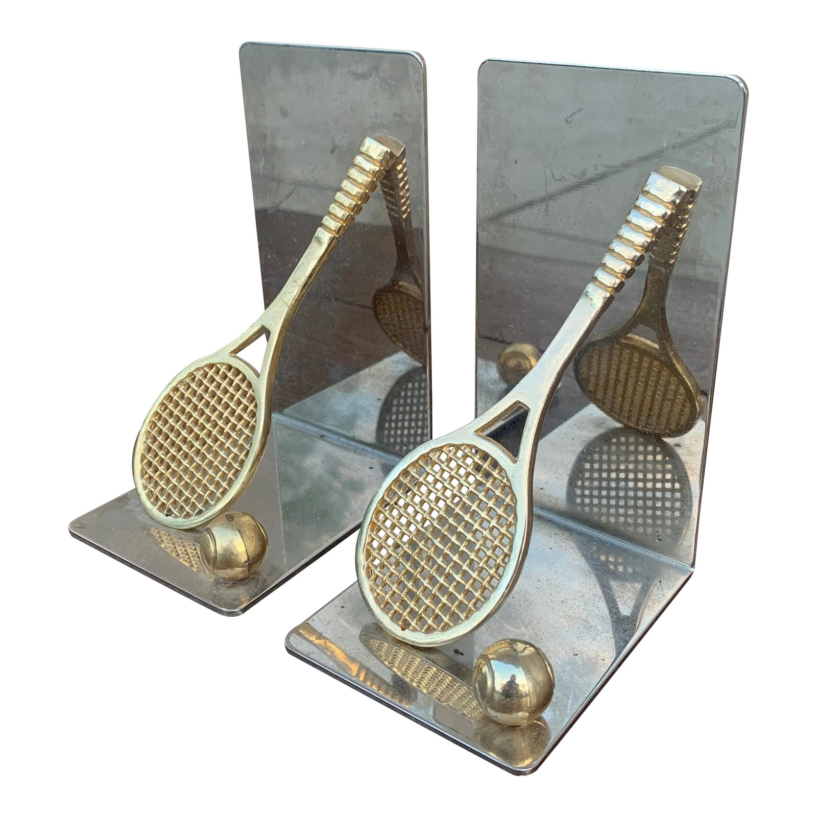 Vintage Cast Brass Double Tennis Racket Bookends, Pair: A beautiful pair of cast brass bookends in the form of two tennis rackets and tennis balls. USA, Circa 1980s Measures: 4"W x 3"D x 5.5"H. Good original vintage condition. Condition: Alterations: