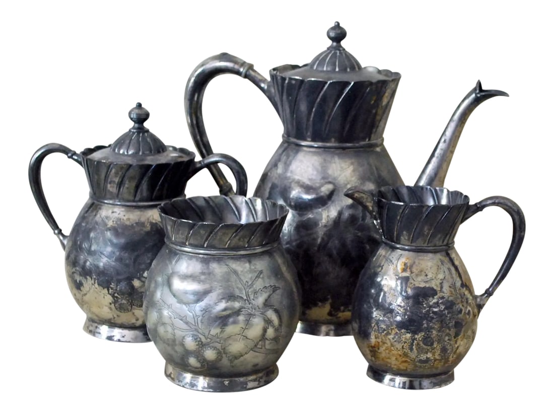 Antique Victorian Silver Plate Tea Service - Set of Four: This antique Victorian silver plate tea set by Meriden Brittania, dating to about the 1870s, has a wonderful repousse and engraved design featuring birds, leaves, and berries. The set includes a