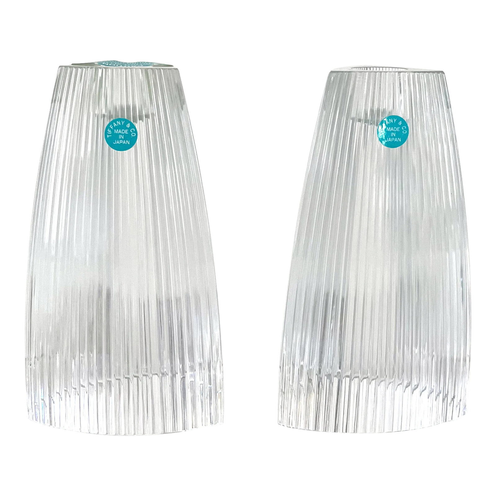 Tiffany Crystal Candleholders, a Pair: Gorgeous and rare pair of Tiffany crystal candleholders. Rounded triangular shape with striated sides, these make a fabulous modern table statement. Mint condition, never used, items still retain
