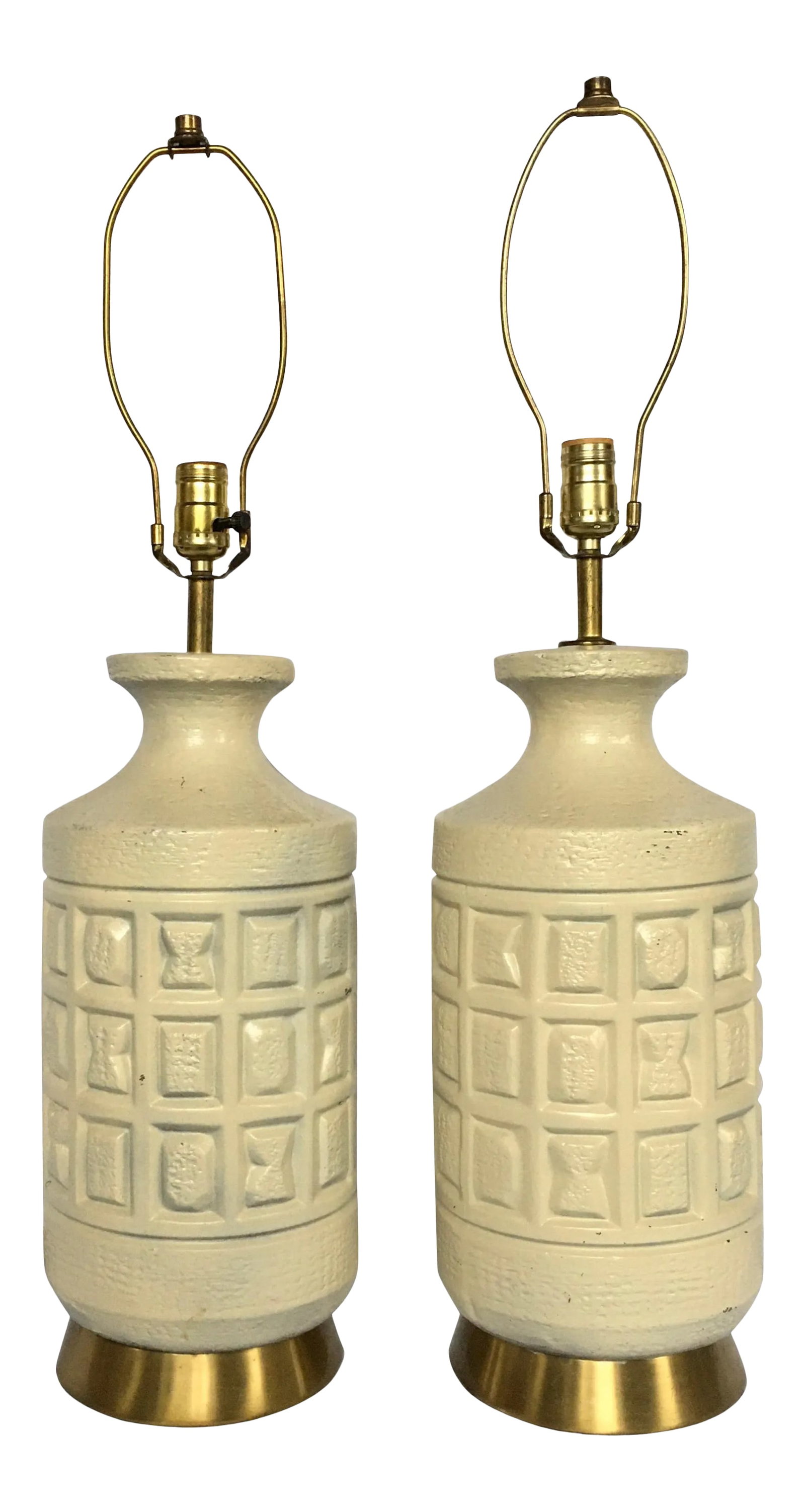 Brutalist Mid-Century Modern Cubist Pottery Table Lamps- A Pair: Mid-Century Modern Brutalist pottery table lamps. These cubist form table lamps feature sculptural matte cream pottery bases imprinted with geometric forms mounted on brass bases. Measures: Height to 