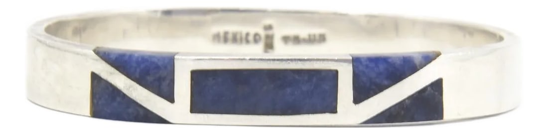 Late 20th Century Modernist Geometric Lapis Lazuli Sterling Silver Bangle Bracelet: Vintage modern geometric design sterling silver bangle bracelet from the silversmiths in Taxco, Mexico with inlay lapis lazuli. Marked 925 Mexico TM-115 Interior of the cuff measures a total
