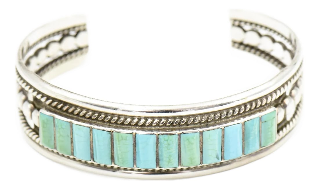Late 20th Century Vintage Southwestern Turquoise Sterling Silver Cuff Bracelet: Southwestern Turquoise Silver Cuff Bracelet features 12 rows of rectangular turquoise stones set in a channel inlay design. The bracelet is framed with twisted rope detail along the top and bottom
