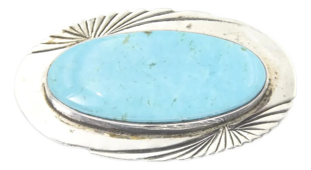 Vintage Southwestern Native American Style Turquoise Sterling Silver Brooch: Vintage Southwestern brooch with a bezel set oval turquoise cabochon mounted in a sterling silver frame with a wing etched on the top and bottom edge. Marked Sterling VO Condition: Alterations: