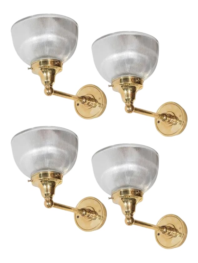 Set of Four American Classical Brass and Halophane Glass Sconces: These wonderful set of four sconces feature a reverse domed ribbed halothane glass shade with a polished brass arm with classical detailing. They have been newly rewired and are in excellent