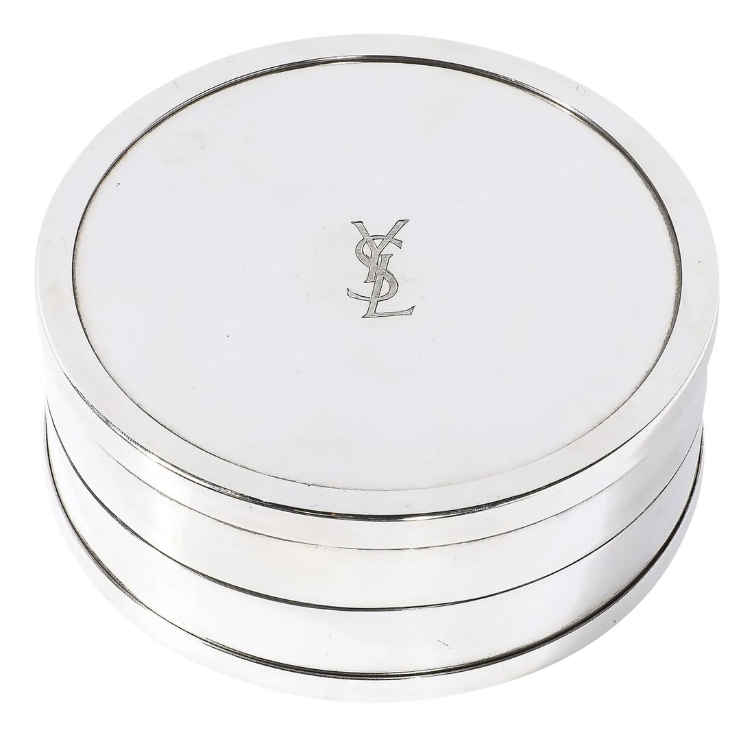 Yves Saint Laurent Decorative Box With Silk Liner: This sleek and beautifully rendered Yves Saint Laurent Decorative Box W/ Silk Inlay originates from France during the 20th Century. A cylindrical composition with a hinged lid and circular raised