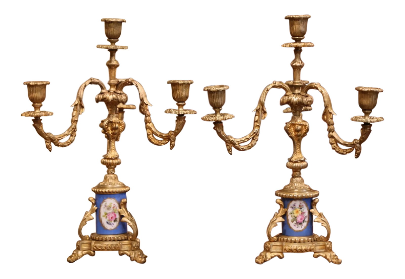 Pair of 19th Century French Louis XVI Gilt Bronze and Porcelain Candelabras: Elevate a mantel or dining table with this refined pair of French Louis XVI candelabras, crafted circa 1870 with exceptional decorative detail. Each antique piece stands on an elegant tripod base