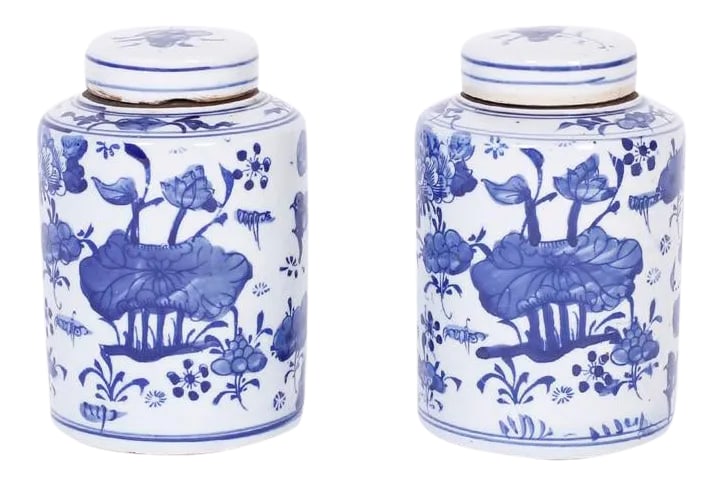 Blue and White Porcelain Tea Jars - a Pair: Pair of blue and white porcelain lidded tea jars with a cylindrical form and hand decorated with flowers and leaves. Condition: Imperfections: No Imperfections Origin: China Materials &