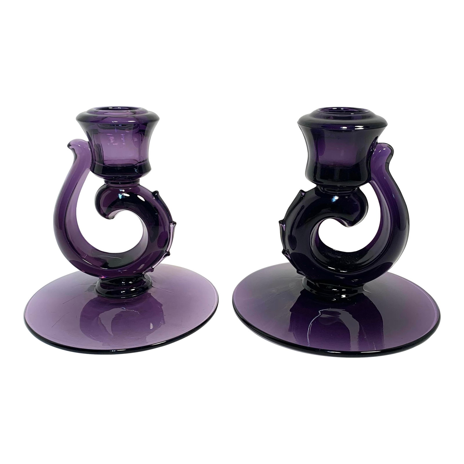 Antique Amethyst Glass Candle Holders Pair Art Nouveau: This antique pair of amethyst glass candle holders dates to the late 19th to early 20th century and have been irradiated, resulting in their deep purple hue. Each holder stands 4.5 inches tall and