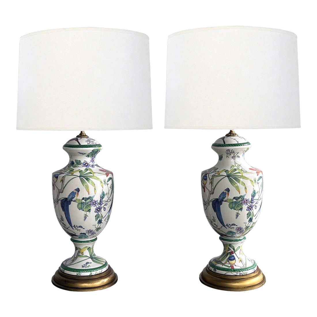 Pair of Italian Hand-Painted Porcelain Baluster-Form Lamps With Bird Motifs: each artist-signed lamp of baluster form with waisted neck above an ovoid body all over a splayed foot; resting on a turned gold-painted wooden base; each adorned with well-executed hand-painted