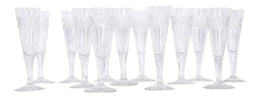 French 19th Century Cut Crystal Champagne Flutes - Set of 13: Set of 13 French glasses, circa 1820. These crystal flutes have a diamond pattern around the bowl finished with a scalloped edge, tapering down to faceted stems and solid bases-several have tiny air