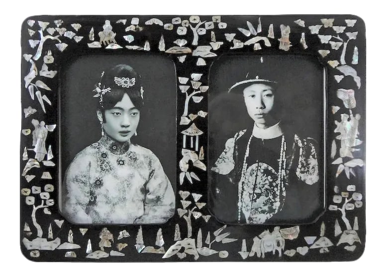 Early 20th Century Papier Mache Double Picture Frame: A rare early 1900's Papier Mache Chinese double window picture frame. Frame is inlaid with Mother of Pearl figures and shapes. They include trees, man holding a fan over a woman, man on ox, hut, man a