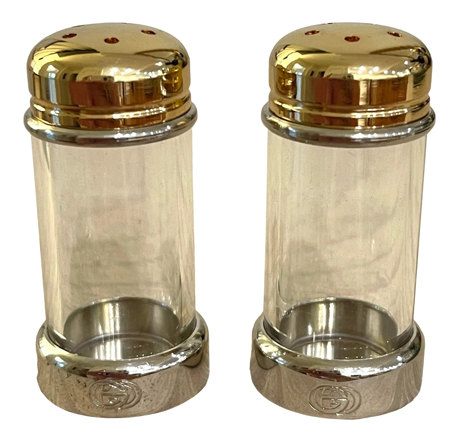 Gucci Silver and Brass Salt and Pepper Shakers: Never used GUCCI salt and pepper shakers. Glass body with silver and brass detailing. Double G's engraved on bottom. Made in Italy. Includes original packaging and price tag. Immaculate condition.