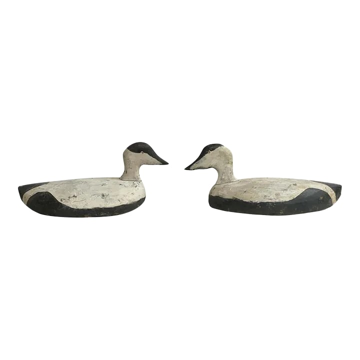Pair of Early 20th Century American Eider Duck Decoys: A special and whimsical pair of early 20th century American hands-carved wood Eider Duck decoys with black and white painted bodies and eyes. Condition: Alterations: Original Condition Unaltered Imper