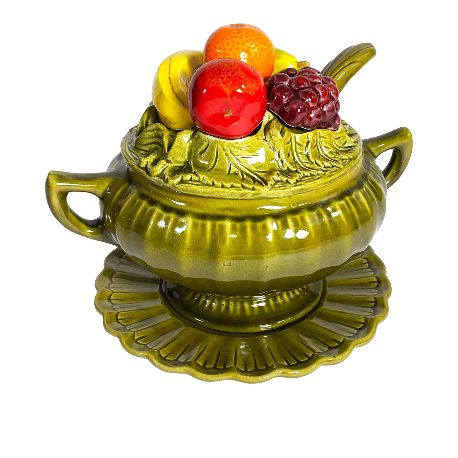Mid-Century Majolica California Pottery Olive Green Della Robbia Soup Tureen Fruit Trompe L'Oeil: Mid century tureen with plate and serving ladle Avocado green, lid with trompe l'oeil fruit (banana, apple, orange, pear, purple grapes) 10" tall x 11" wide x 10" deep Plate: 10" diameter Marked on