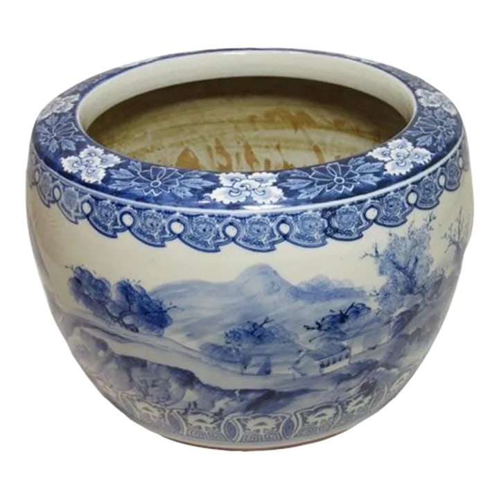 Large Chinese Porcelain Cachepot: Large Chinese porcelain cachepot, c.1930's Made of thick heavy porcelain, decorated in blue and white showing houses amongst trees and mountains. The top and bottom trimmed with flowers and a